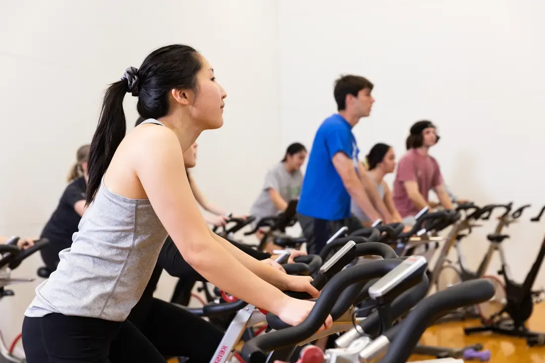 Students on stationary bicycles.